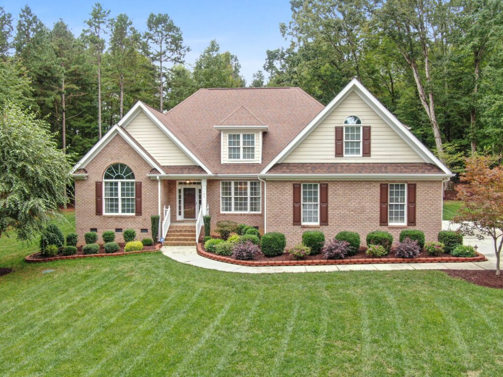 A cozy brick house with grass lawn